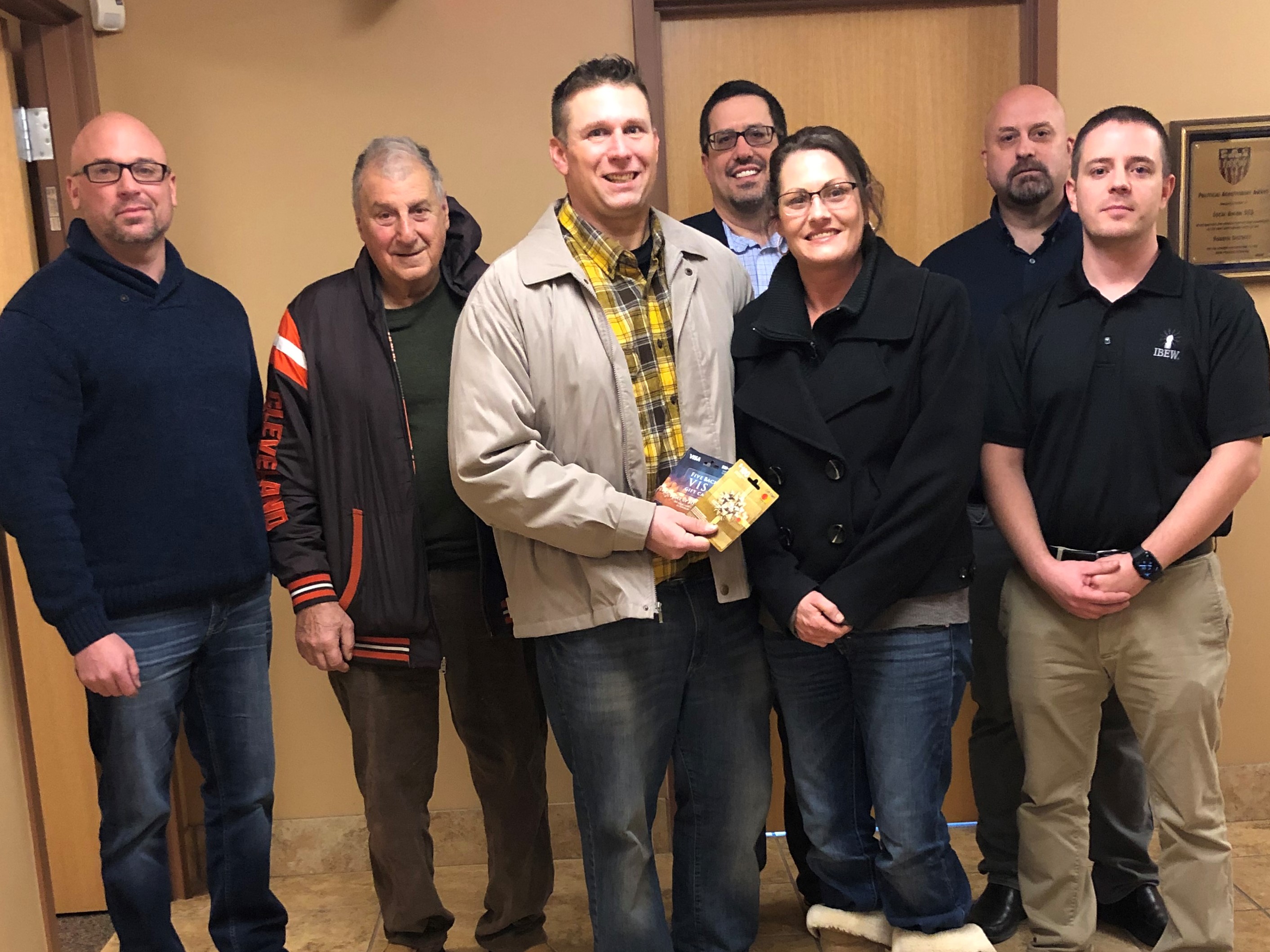 Veteran family poses with electricians