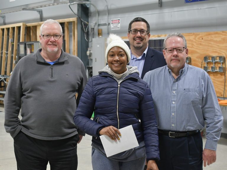 Veteran poses with electricians