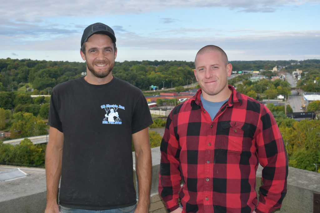 CR Electric crew standing atop Premier Bank tower