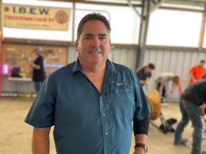 Ed Emerick standing in the electrician section