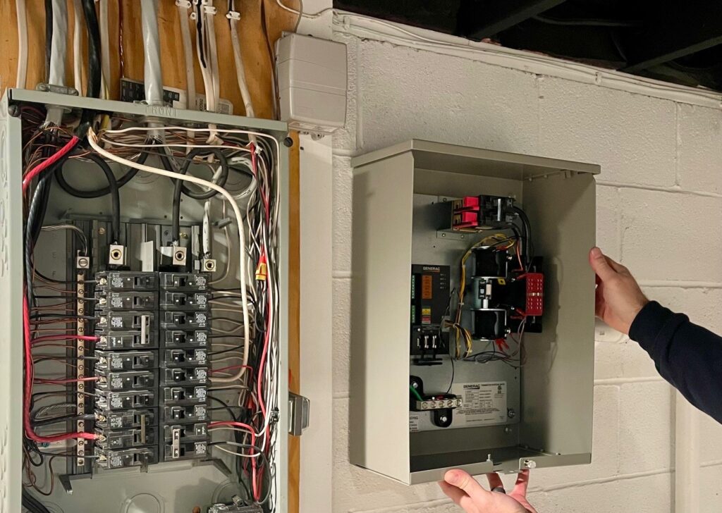Transfer switch box placed next to electrical panel.