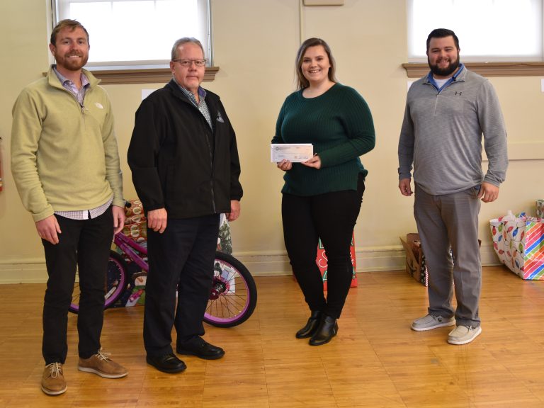 Representatives from IBEW Local 64 present a check to the YWCA Mahoning Valley.