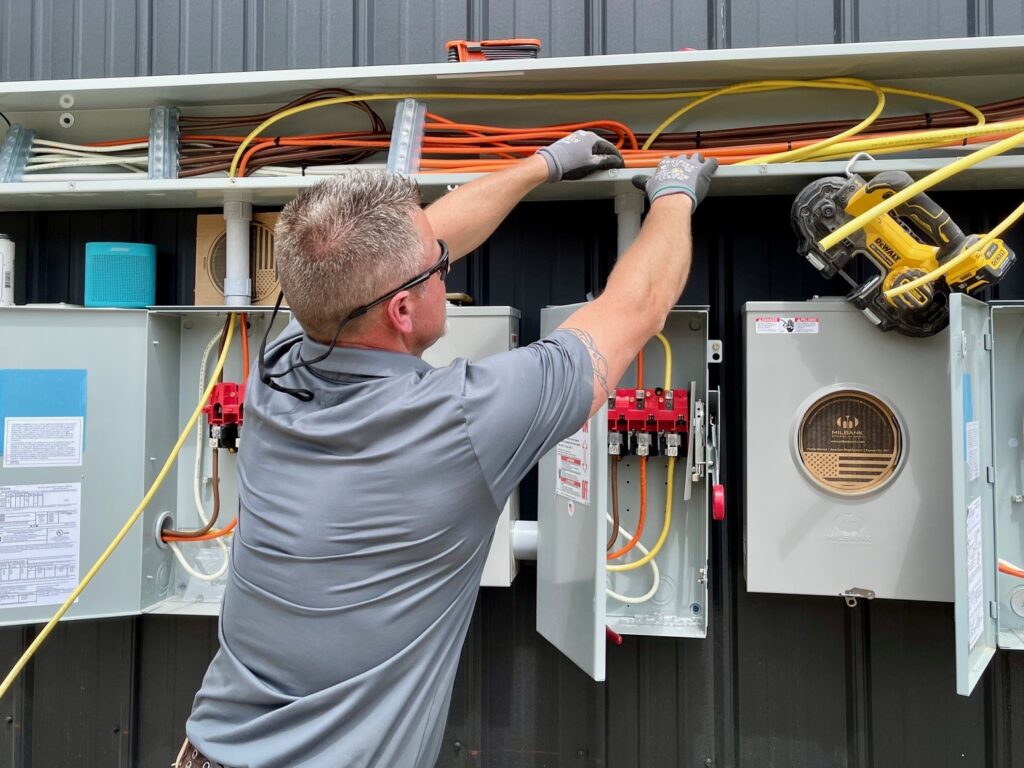Jamie Henderson, of Boot Electric, outside service at Wedgewood Plaza.