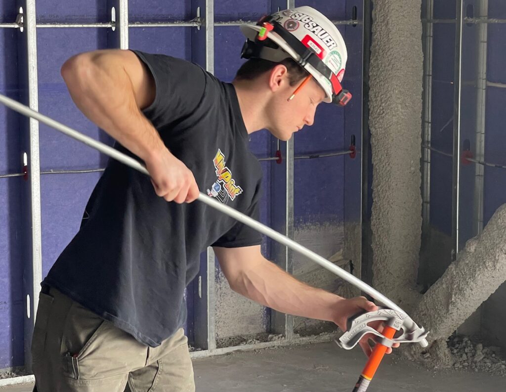 Second-year apprentice, Joe Hawkins, of University Electric, bending conduit.