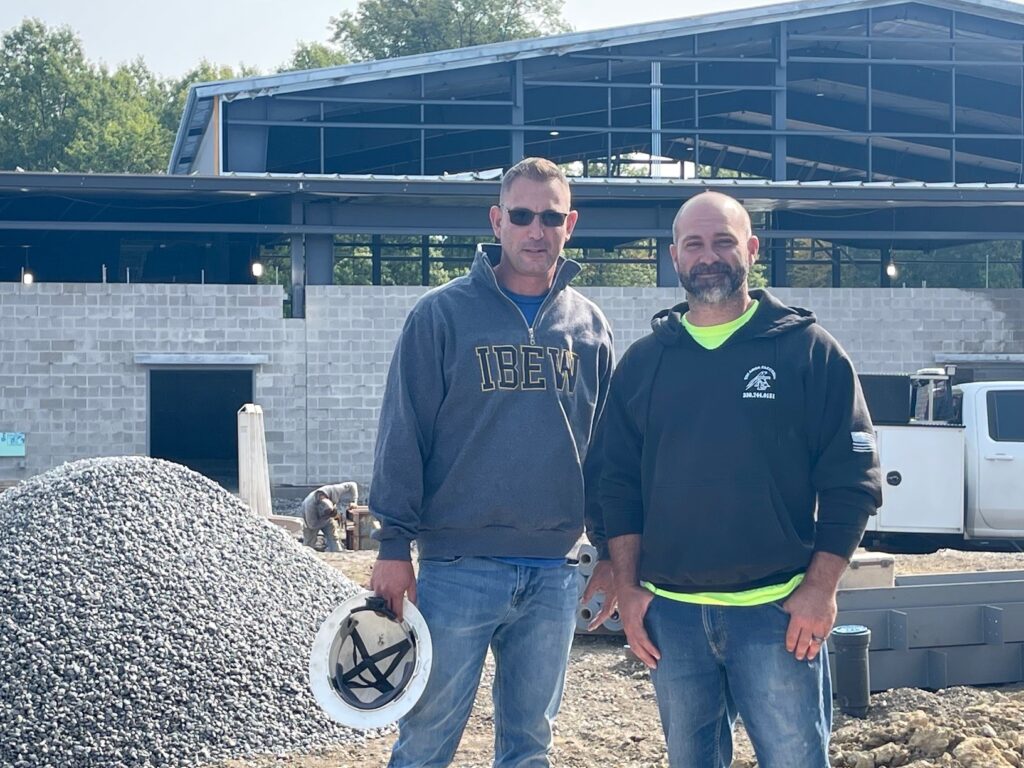 Kenny Lucas, IBEW Local 64 president/organizer, with Chris Bako, of Tri-Area Electric, outside the MCCTC technology building.