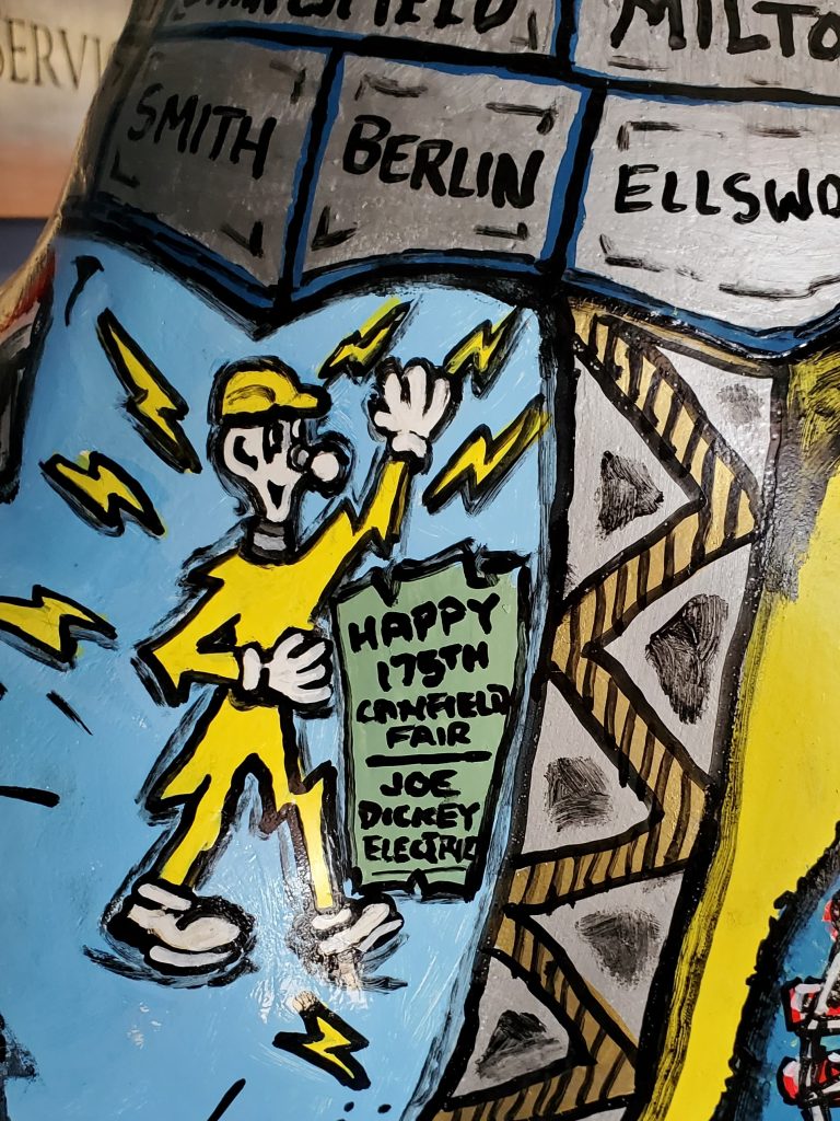 Local artist Bob Barko incorporated "Joe" Dickey Electric into his design for a rooster statue which the company sponsored him to paint.