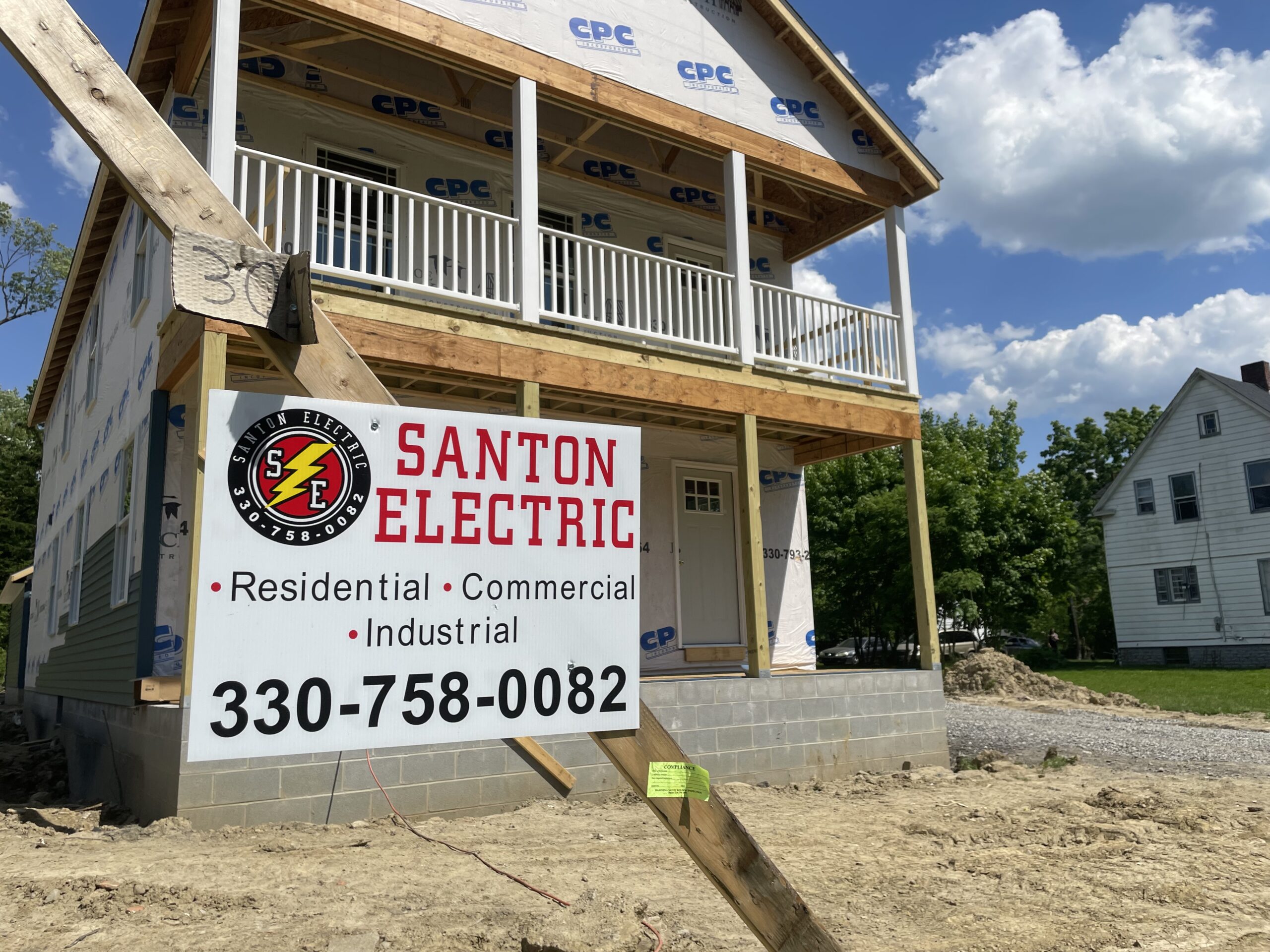 Santon Electric sign outside duplex on Glenwood Avenue in Youngstown.