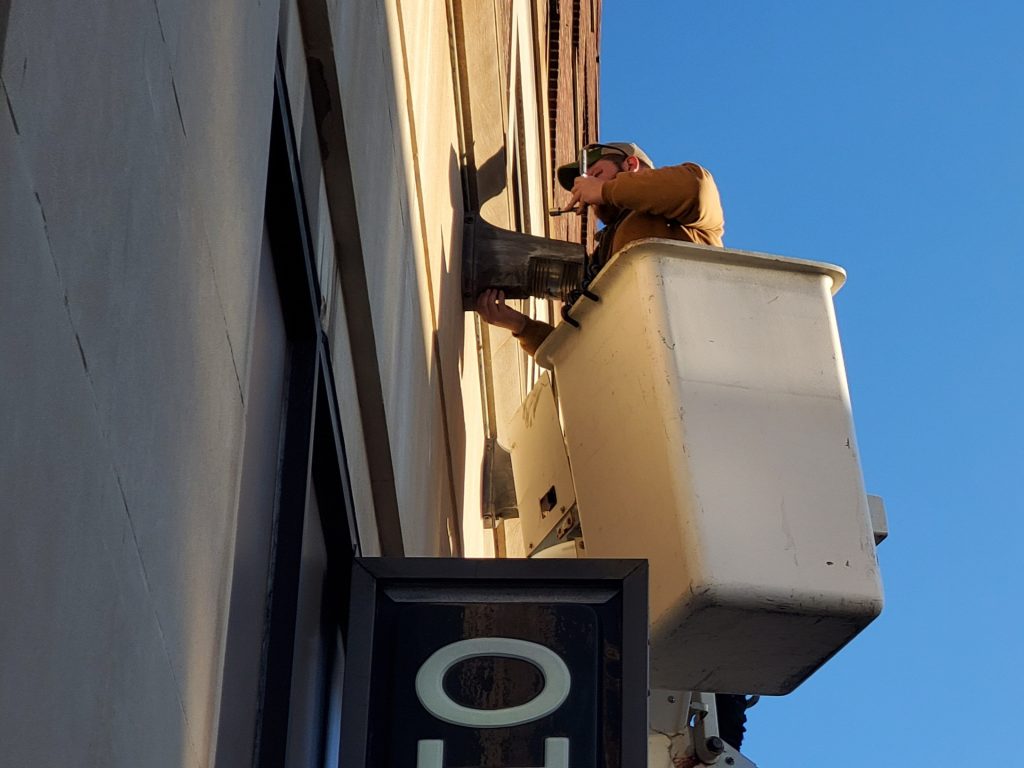Electrician works on a light.