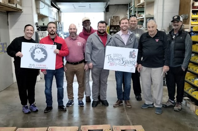 Representatives of IBEW Local 64, IBEW Local 573 and Santon Electric pose with their donations to the Boo Squad’s Thanksgiving Food Drive.
